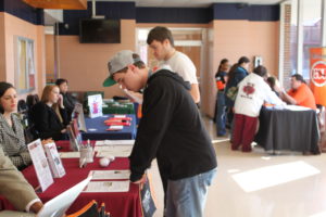Students visit with representatives from other colleges during transfer day. 